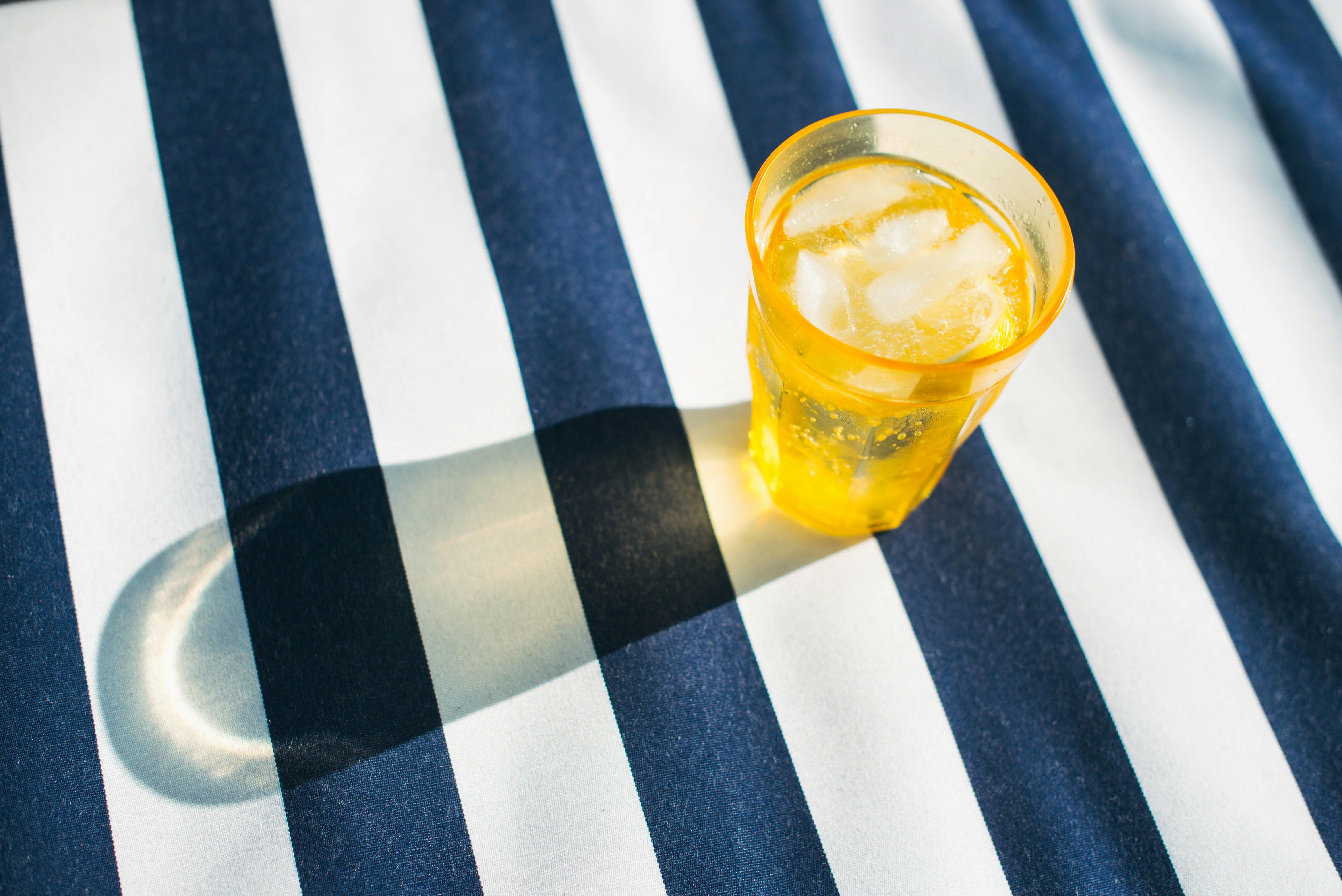 clear drinking glass with yellow liquid